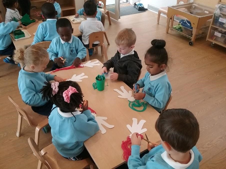 children at a desk working at a Montessori Pre-school and Nursery Serving Colindale, Edgware & St Albans UK